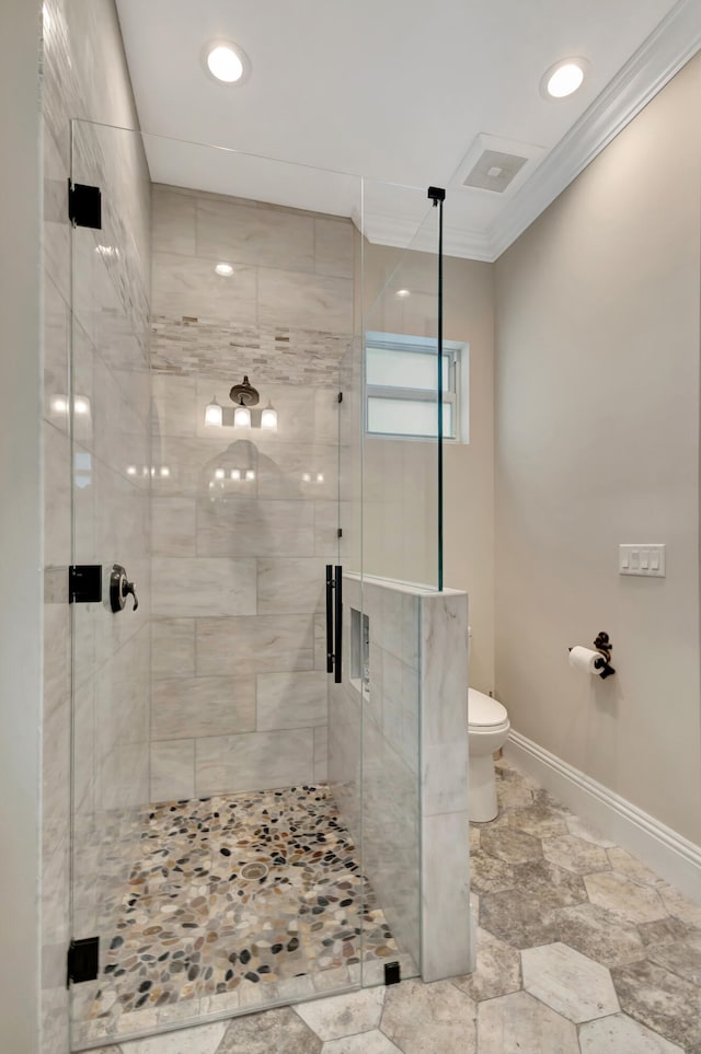 bathroom with ornamental molding, walk in shower, and toilet