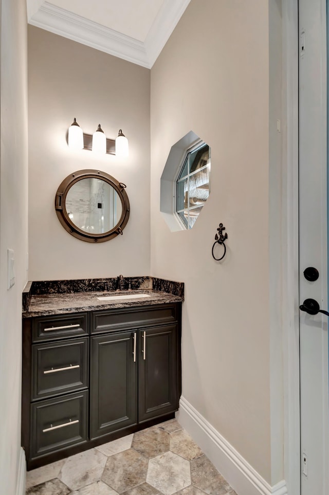 bathroom featuring ornamental molding and vanity