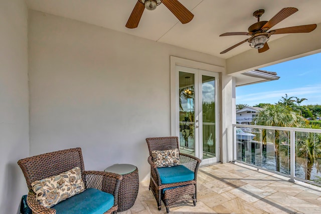 exterior space featuring ceiling fan and a water view