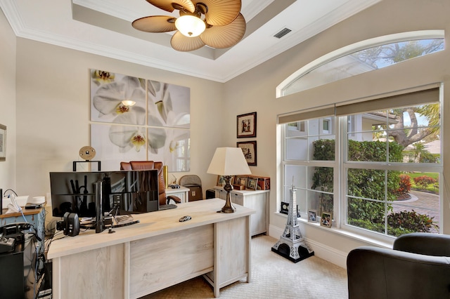 carpeted office featuring ceiling fan, ornamental molding, and a tray ceiling