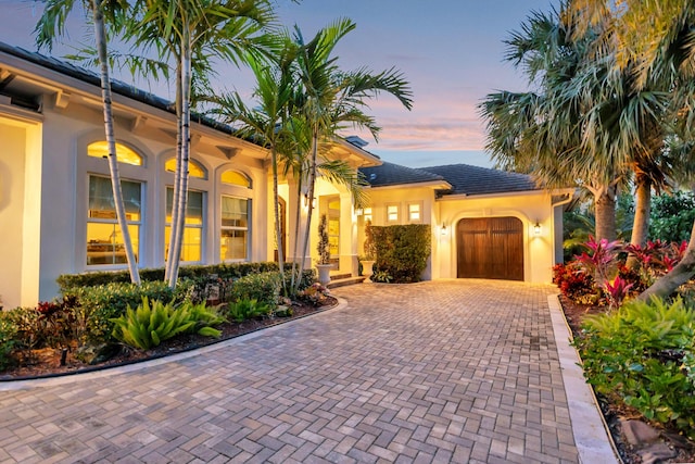 mediterranean / spanish-style home featuring a garage