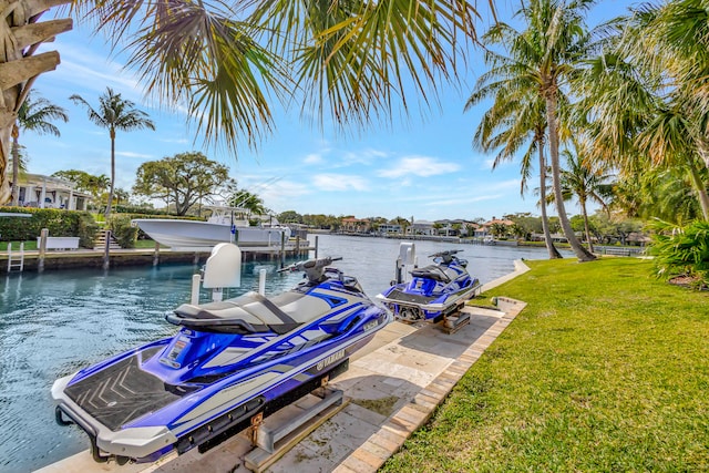 dock area featuring a lawn and a water view