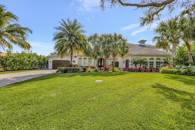 view of front of house featuring a garage and a front yard