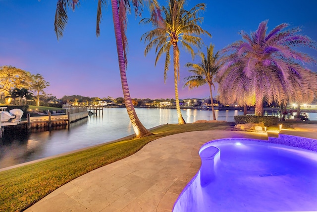 pool at dusk with a water view