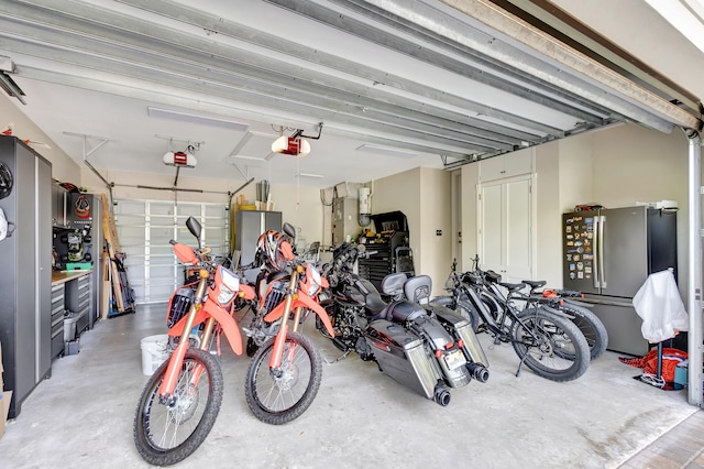 garage featuring a garage door opener and stainless steel fridge