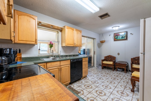 kitchen featuring white refrigerator, a textured ceiling, backsplash, dishwasher, and sink