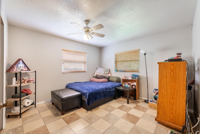 bedroom featuring ceiling fan, light tile floors, and multiple windows