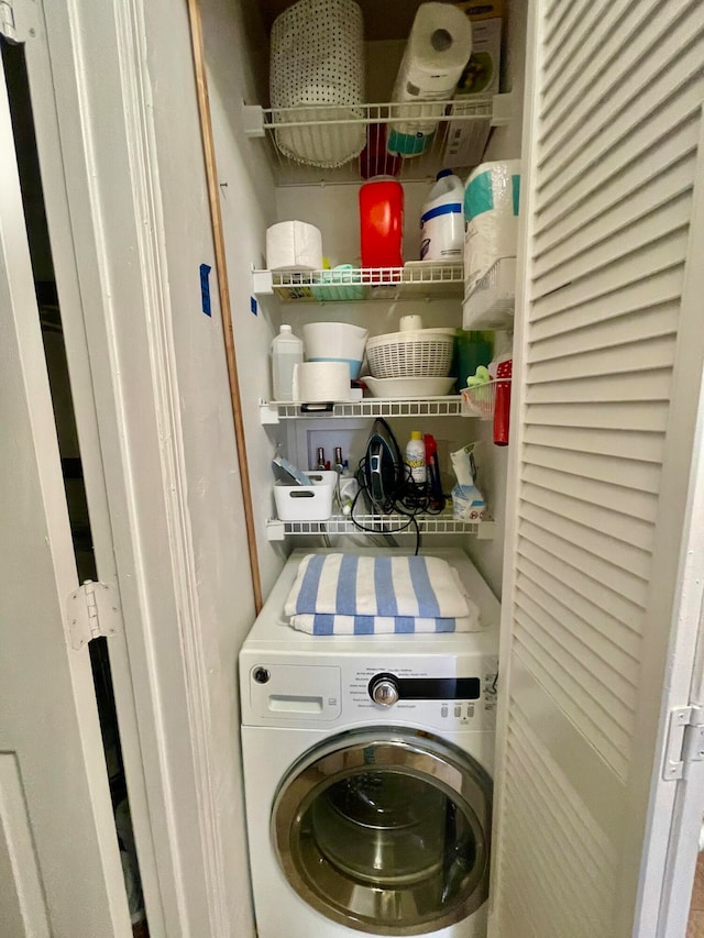 clothes washing area with washer / dryer