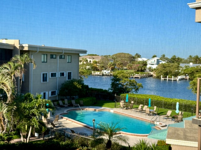 view of swimming pool featuring a water view and a patio area