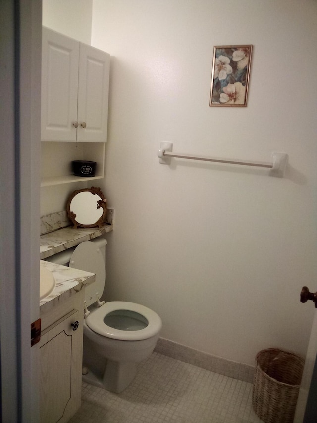 bathroom featuring vanity, toilet, and tile patterned flooring