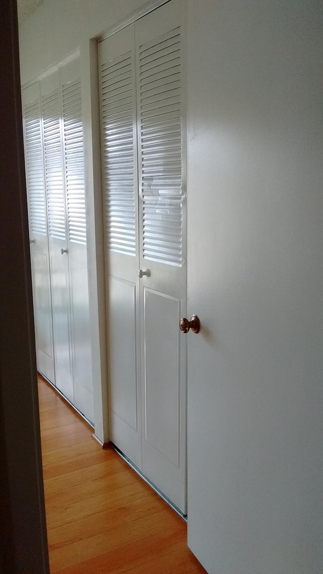 hallway with light wood-type flooring