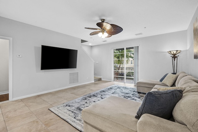 tiled living room with ceiling fan