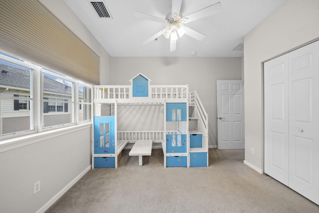 unfurnished bedroom featuring carpet flooring, a closet, and ceiling fan