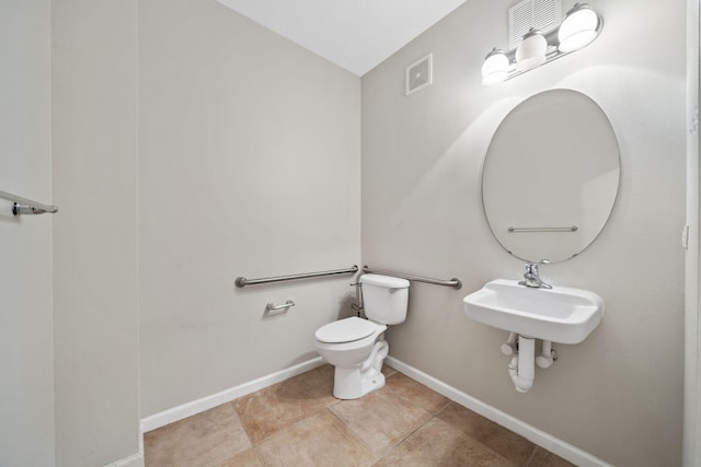 bathroom with sink, tile floors, and toilet