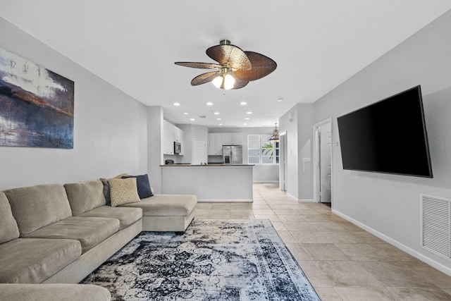 tiled living room featuring ceiling fan