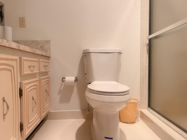 bathroom featuring walk in shower, tile floors, and toilet