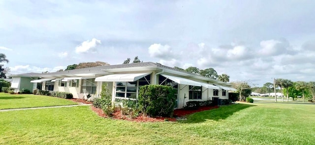 view of side of property featuring a yard