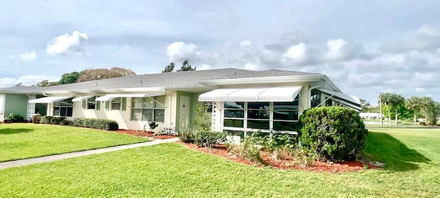 rear view of house featuring a yard