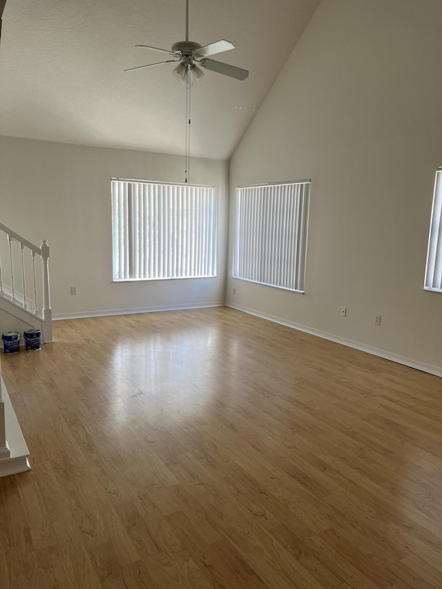 spare room featuring ceiling fan, high vaulted ceiling, and light hardwood / wood-style flooring