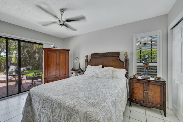 bedroom featuring access to exterior, ceiling fan, light tile patterned flooring, and multiple windows