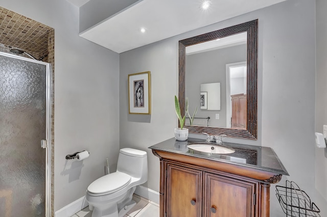 bathroom featuring tile patterned flooring, vanity, toilet, and an enclosed shower