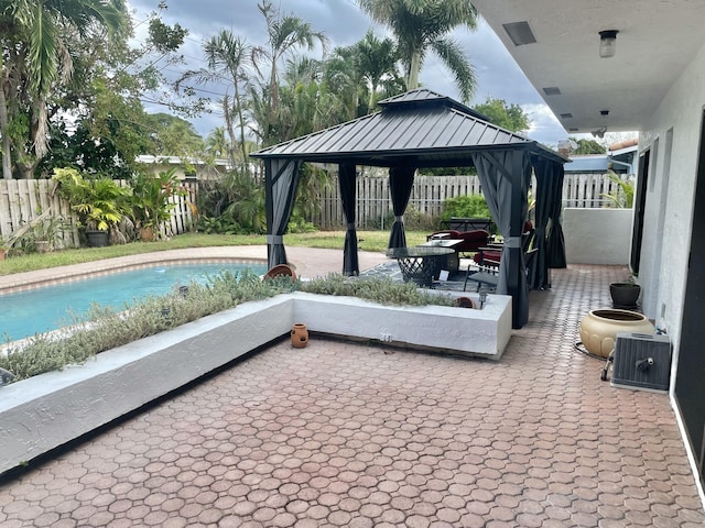 view of patio / terrace with a gazebo and a fenced in pool