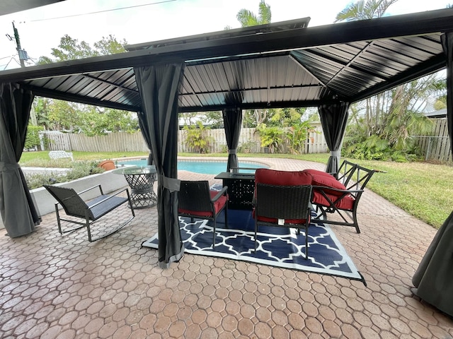 view of patio with a gazebo and a fenced in pool