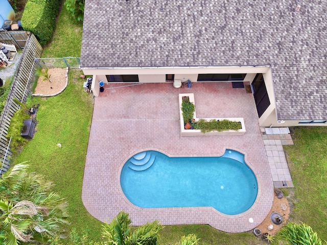 view of pool with a yard