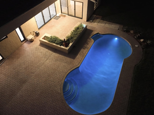 pool at night with a jacuzzi