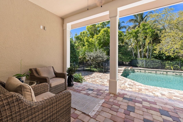 view of patio / terrace with a fenced in pool