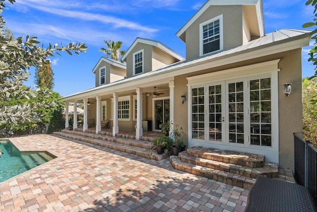 rear view of property with a patio area, ceiling fan, and french doors