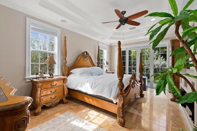 tiled bedroom with a raised ceiling, ornamental molding, ceiling fan, and french doors