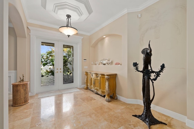 tiled foyer with ornamental molding and french doors