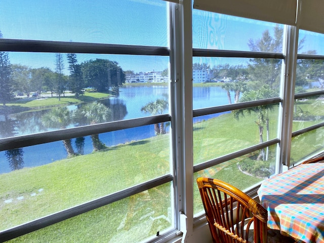 sunroom / solarium with a water view