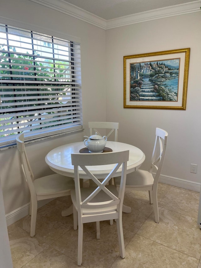 dining area featuring light tile floors and ornamental molding