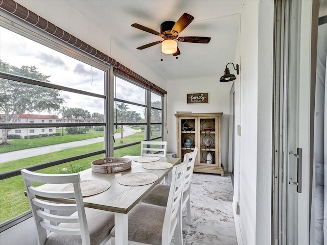 sunroom featuring ceiling fan