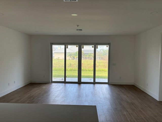 spare room featuring dark hardwood / wood-style floors