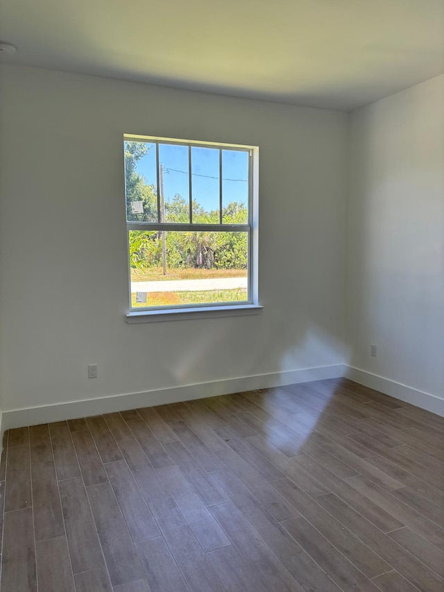 spare room with dark hardwood / wood-style floors