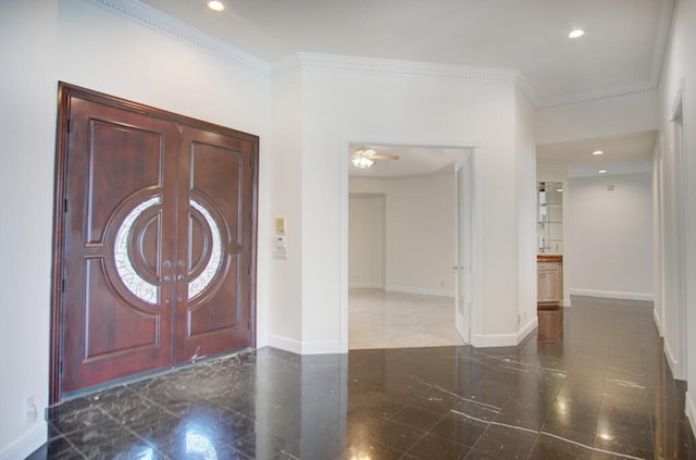 tiled entryway with ornamental molding and ceiling fan