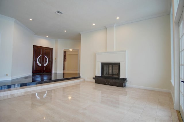 unfurnished living room with ornamental molding and light tile floors