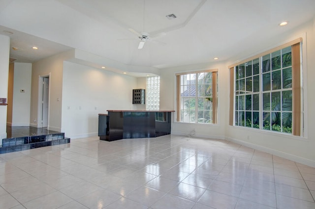 interior space featuring light tile flooring and ceiling fan