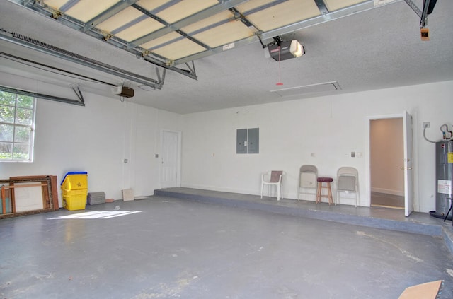 garage featuring electric water heater and a garage door opener