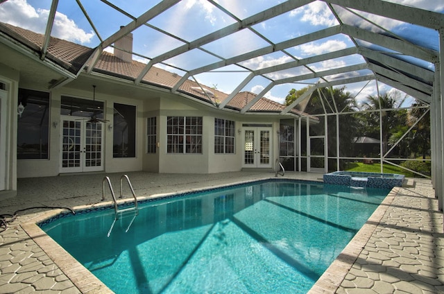 view of pool featuring a patio, an in ground hot tub, french doors, and glass enclosure