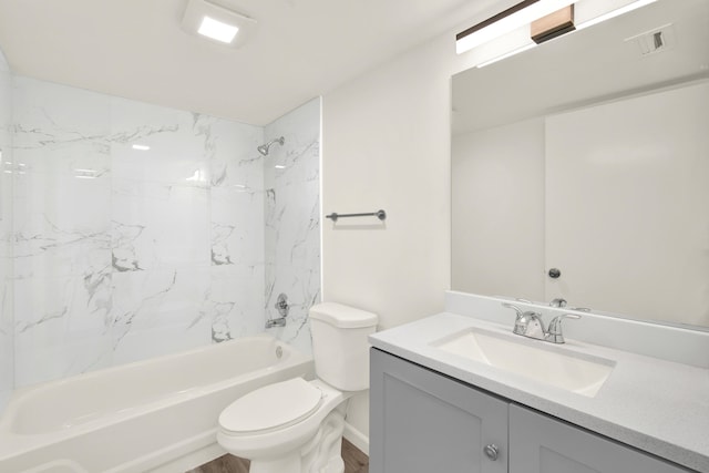 full bathroom featuring hardwood / wood-style flooring, toilet, tiled shower / bath combo, and vanity