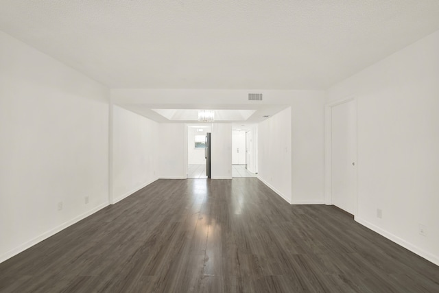 spare room featuring dark wood-type flooring