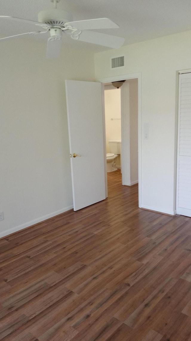 interior space featuring ceiling fan and dark wood-type flooring