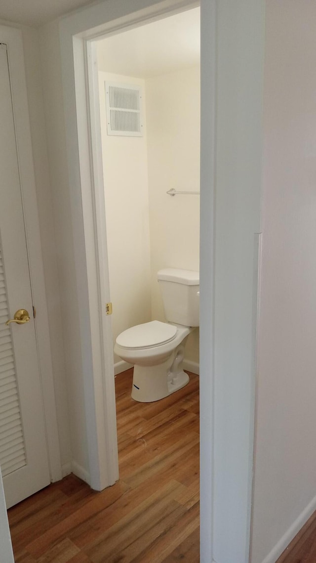 bathroom featuring toilet and hardwood / wood-style flooring