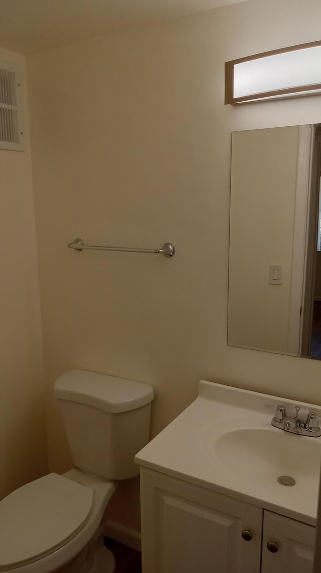 bathroom with toilet and vanity