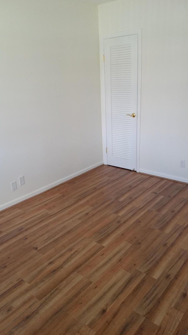 empty room with dark hardwood / wood-style floors