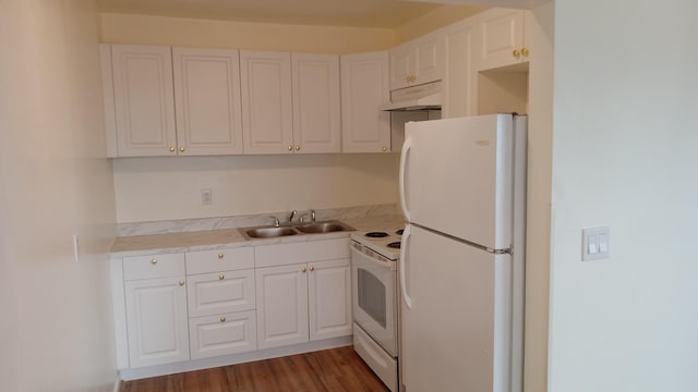 kitchen featuring white appliances, white cabinets, dark wood-type flooring, and sink